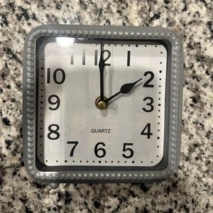 gray small clock for decoration